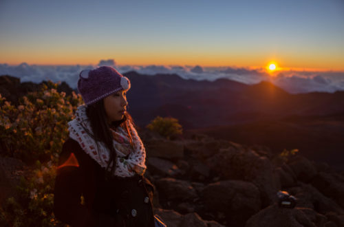 girl posing in front of the Haleakala Crater sunrise